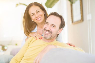 Evde kanepede oturan orta yaş romantik çift