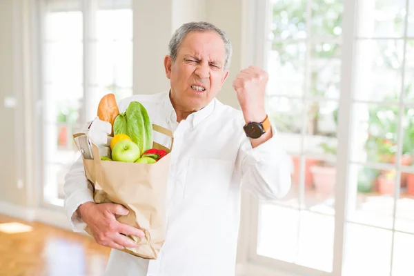 Handsome Senior Man Holding Paper Bag Fresh Groceries Supermarket Annoyed — Stock Photo, Image