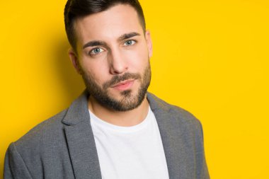 Yakışıklı delikanlı possing ve izole sarı arka plan üzerinde modelleme