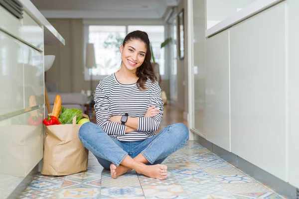 Young Woman Sitting Kitchen Floor Paper Bag Full Fresh Groceries Stock Photo