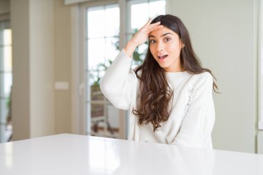 Genç güzel kadın evde beyaz tablo çok mutlu ve gülümseyen uzakta el ile üzerine kafa arıyorum. Arama kavramı.