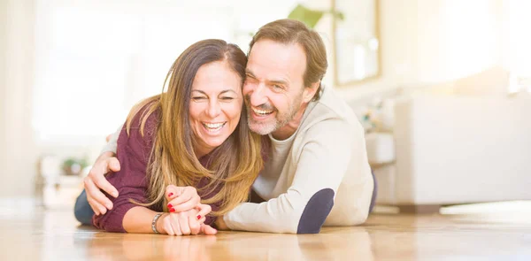Beautiful romantic couple sitting together on the floor at home — Stock Photo, Image