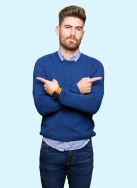 Genç yakışıklı bussines adam işaret parmakları ile her iki taraf için farklı yönde katılmıyorum