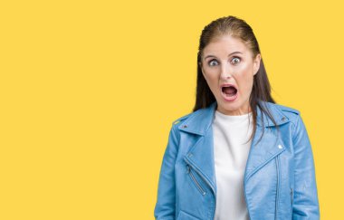 Şüpheci ve alaycı, şok karşısında izole arka plan üzerinde moda deri ceket giymiş güzel orta yaş Olgun kadın ile açık ağız şaşırttı