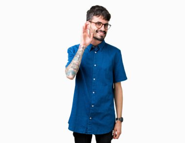 Bir işitme söylenti ya da dedikodu için dinleme kulak üzerinde el ile gülümseyen izole arka plan üzerinde gözlük takan yakışıklı delikanlı. Sağırlık kavramı.