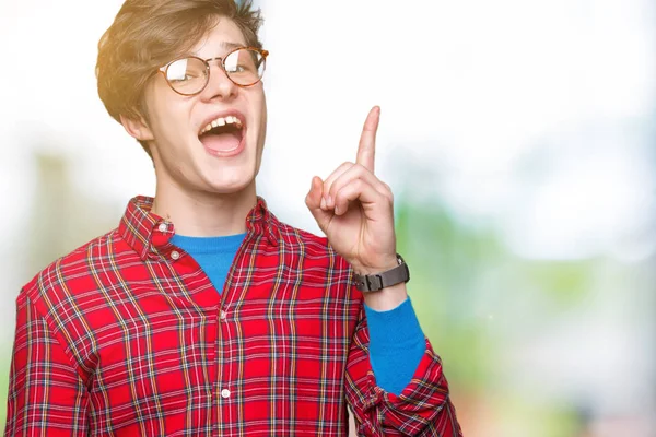 Young Handsome Man Wearing Glasses Isolated Background Pointing Finger Successful — Stock Photo, Image