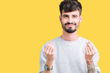 Maaş ödeme için milyoner iş soran izole arka plan yapıyor para hareketi el ile üzerinden sweatshirt giyen genç yakışıklı adam