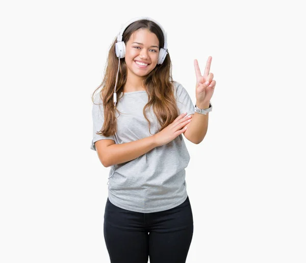 Mujer Hermosa Joven Con Auriculares Escuchando Música Sobre Fondo Aislado —  Fotos de Stock