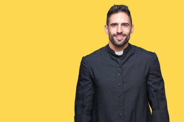 Genç Hıristiyan rahip yüzünde mutlu ve güzel bir gülümseme ile izole arka plan üzerinde. Şanslı kişi.