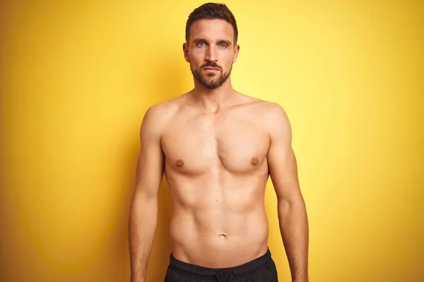 Young Handsome Shirtless Man Isolated Yellow Background Serious Expression Face — 스톡 사진