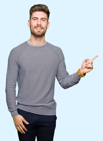 잘생긴 젊은이 얼굴에 미소와 줄무늬 스웨터를 카메라를 손가락으로 가리키는 — 스톡 사진