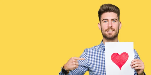 Young Handsome Man Holding Paper Red Heart Surprise Face Pointing — Stock Photo, Image
