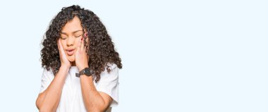 Beyaz t-shirt giyen kıvırcık saçlı Genç güzel kadın yorgun eller yüz, depresyon ve üzüntü kapsayan, üzgün ve sorun için tahriş