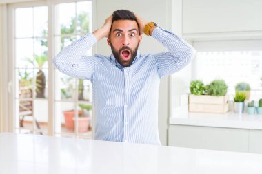 Yakışıklı İspanyol iş adamı Crazy ve baş elleri ile korkmuş, korkmuş ve açık ağız ile şok şaşırttı