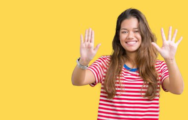 Genç güzel esmer kadın giyiyor çizgili t-shirt gösterilen ve parmakları ile işaret izole arka plan üzerine gülümseyen ise kendinden emin ve mutlu on numara.