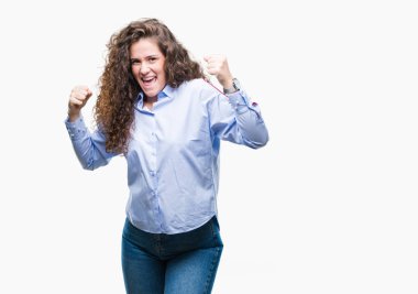 Gülümseyen ve başarı için çığlık elgant göz izole arka plan çok mutlu ve heyecanlı kaldırdı, silah ile kazanan jest yapıyor üzerinde giyen güzel esmer kıvırcık saçlı Genç kız. Kutlama kavramı.