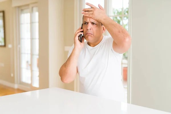 Middle Age Man Calling Using Smartphone Stressed Hand Head Shocked — Stock Photo, Image