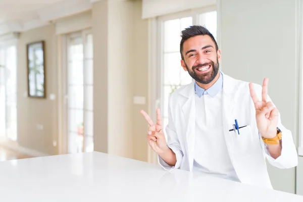 Handsome Hispanic Doctor Therapist Man Wearing Medical Coat Clinic Smiling — Stock Photo, Image