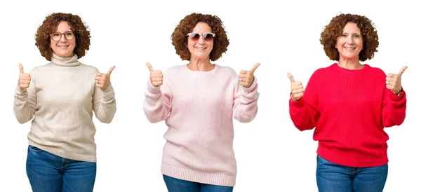 身穿冬衣的中年老妇人身着白色孤立背景的成功标志 用手做积极手势 竖起大拇指微笑 看着相机欢快的表情 胜利者的手势 — 图库照片