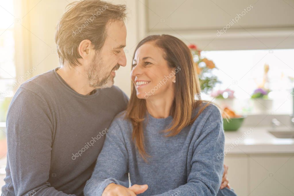 Romantic middle age couple sitting together at home