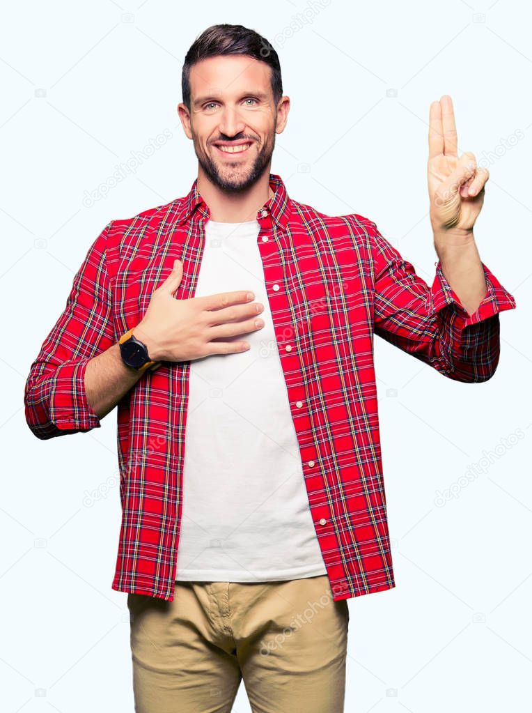 Handsome man wearing casual shirt Swearing with hand on chest and fingers, making a loyalty promise oath