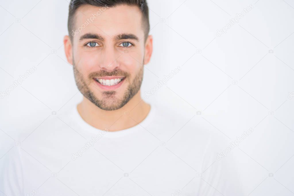 Young handsome man smiling happy wearing casual white t-shirt ov
