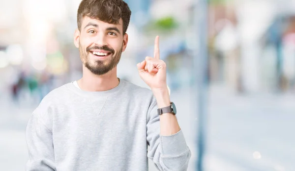 Ung Vacker Man Bär Tröja Över Isolerade Bakgrund Pekande Finger — Stockfoto