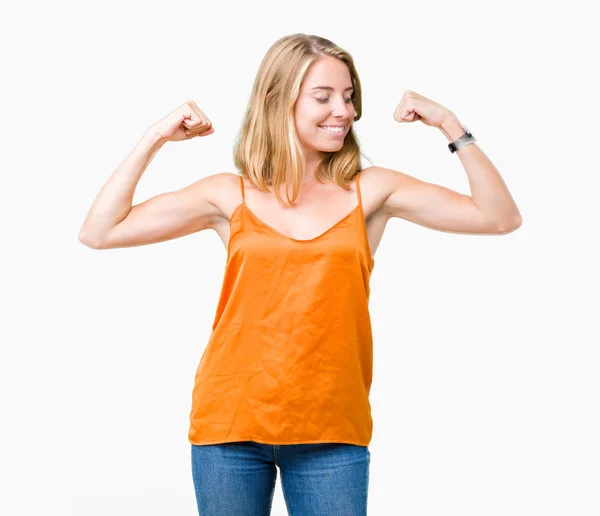 美しい若い女性の誇り笑顔腕の筋肉を示す分離の背景にオレンジ色のシャツを着てします フィットネスの概念 — ストック写真