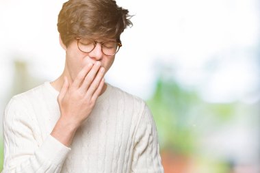 Yakışıklı delikanlı izole arka plan üzerinde gözlük el ağzıyla kapsayan yorgun esneme sıkılmış. Restless ve uyku hali.