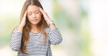 Genç güzel esmer kadın giyiyor çizgili süveter üzerinde arka plan baş baş ağrısı için el ile çünkü izole stres. Migren muzdarip.