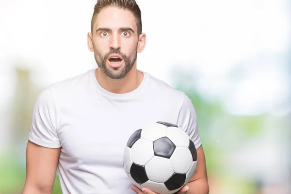 Young Man Holding Soccer Football Ball Isolated Background Scared Shock — Stock Photo, Image