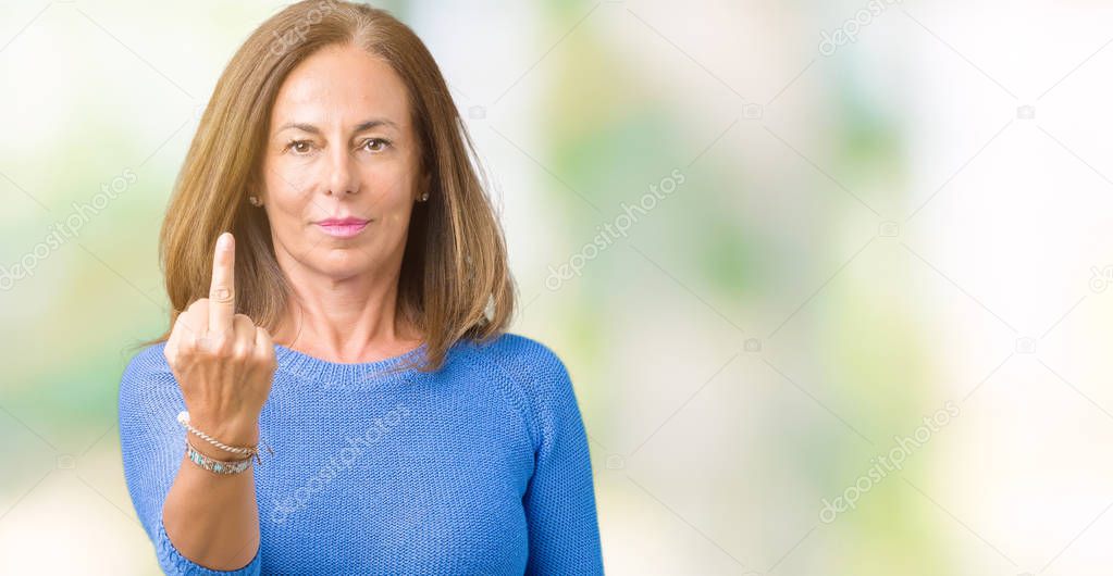 Middle age beautiful woman wearing winter sweater over isolated background Showing middle finger, impolite and rude fuck off expression
