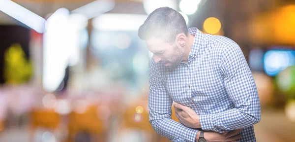 Joven Hombre Guapo Sobre Fondo Aislado Con Mano Estómago Porque — Foto de Stock