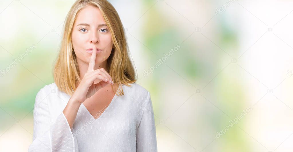 Beautiful young elegant woman over isolated background asking to be quiet with finger on lips. Silence and secret concept.