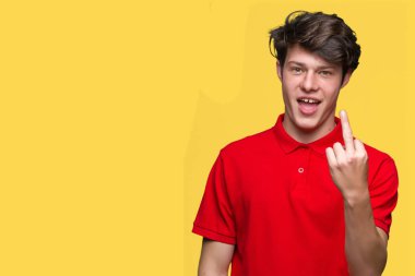 Young handsome man wearing red t-shirt over isolated background Showing middle finger, impolite and rude fuck off expression