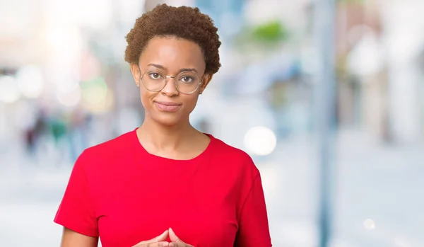 Beautiful young african american woman wearing glasses over isolated background Hands together and fingers crossed smiling relaxed and cheerful. Success and optimistic