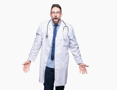 Handsome young doctor man over isolated background In shock face, looking skeptical and sarcastic, surprised with open mouth clipart