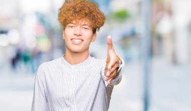 Tebrik ve konuksever dost sunan karşılıklı gülümseyen şık gömlek giymiş afro saçlı Genç yakışıklı iş adamı. Başarılı iş.