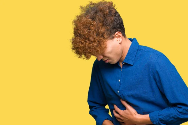 Young handsome elegant man with afro hair with hand on stomach because nausea, painful disease feeling unwell. Ache concept.