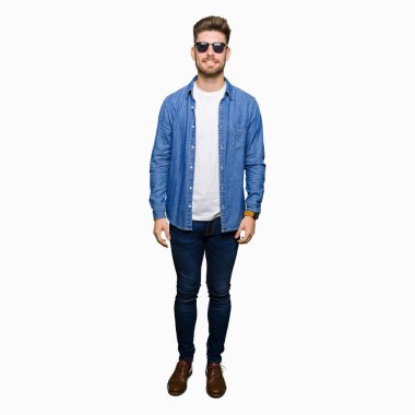 Yüzünde mutlu ve güzel bir gülümseme ile kot ceket giyen genç yakışıklı zarif adam. Şanslı kişi.