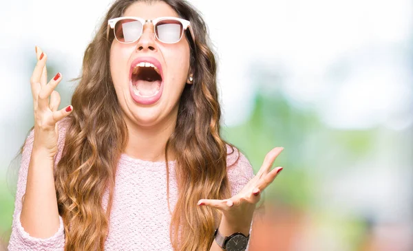 Young Beautiful Woman Wearing Sunglasses Pink Sweater Crazy Mad Shouting — Stock Photo, Image