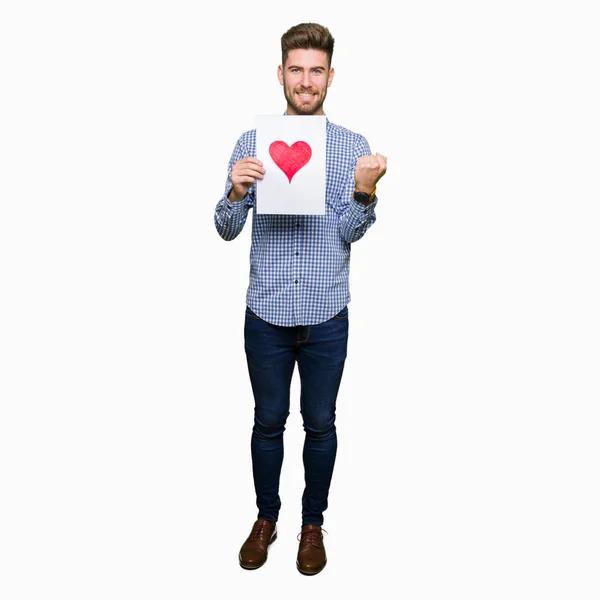 Young Handsome Man Holding Paper Red Heart Screaming Proud Celebrating — Stock Photo, Image