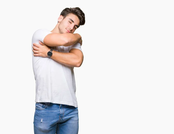 Jovem Bonitão Vestindo Camiseta Branca Sobre Fundo Isolado Abraçando Feliz — Fotografia de Stock