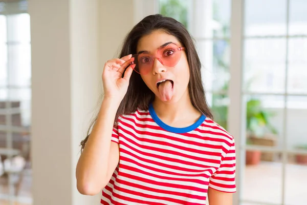Young beautiful woman with tongue out posing doing funny faces