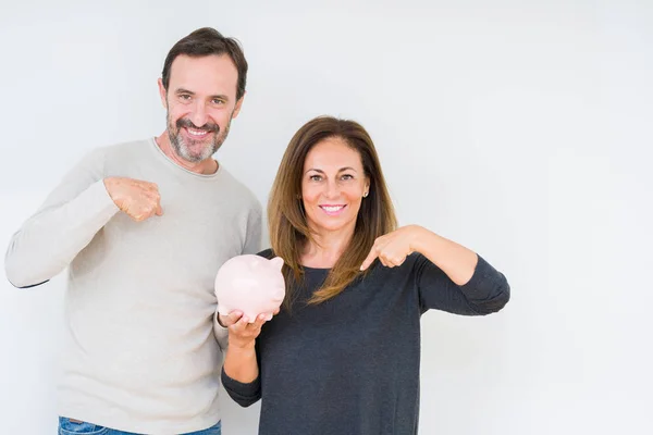 Middle Age Couple Holding Piggy Bank Isolated Background Surprise Face — Stock Photo, Image