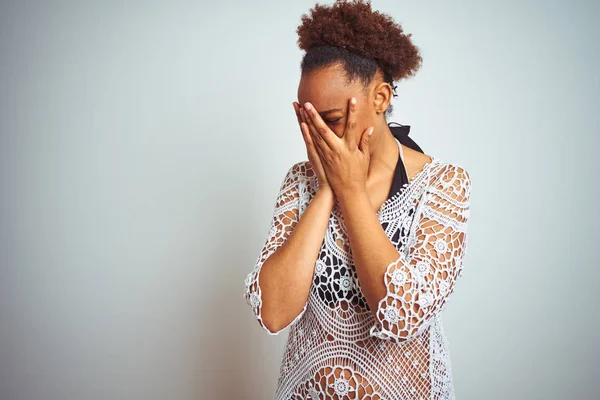 Young african american woman with afro hair wearing a bikini over white isolated background with sad expression covering face with hands while crying. Depression concept.