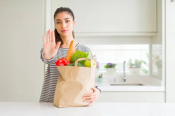 Junge Frau Hält Papiertüte Voller Lebensmittel Mit Offener Hand Und — Stockfoto