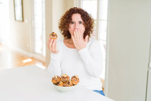 チョコチップを食べる先輩女性が間違いの恥ずかしさにショックを受けた手で口を覆い 恐怖の表情 沈黙に恐怖 秘密の概念 — ストック写真