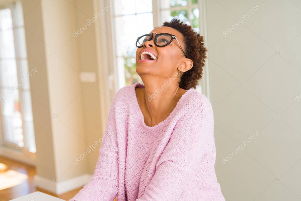 Beautiful young african woman with afro hair wearing glasses