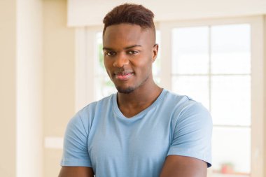 Yakışıklı Afrikalı adam çapraz kolları ile rahat ayakta ve 